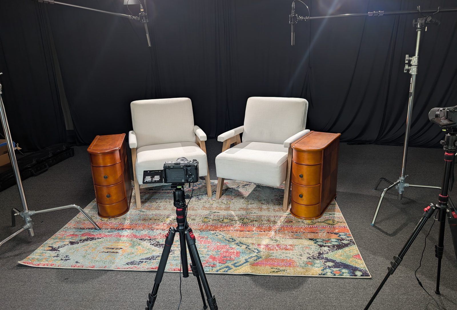 Wide view of the interview set with cameras and lighting in position
